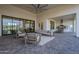 Expansive patio with comfortable seating, outdoor dining area, ceiling fan, and seamless indoor-outdoor living at 11250 W Prospector Dr, Queen Creek, AZ 85144