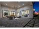 Spacious covered patio with comfortable seating and views of the beautifully landscaped backyard and outdoor kitchen at 11250 W Prospector Dr, Queen Creek, AZ 85144