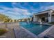 Sparkling pool with custom tile accents and water features complements the home's stylish outdoor living space at 11250 W Prospector Dr, Queen Creek, AZ 85144