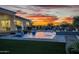 Beautiful backyard pool featuring water features, lush landscaping, and inviting patio at 11250 W Prospector Dr, Queen Creek, AZ 85144