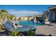 A backyard features a pool, spa, and lounge chairs with lush desert landscaping at 11250 W Prospector Dr, Queen Creek, AZ 85144