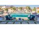 A backyard oasis featuring desert landscaping, a luxurious pool, and a sunning deck with modern seating at 11250 W Prospector Dr, Queen Creek, AZ 85144
