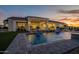 Backyard pool with fountains and covered patio, perfect for entertaining at 11250 W Prospector Dr, Queen Creek, AZ 85144