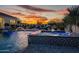 Beautiful pool with water features and relaxing desert landscaping at dusk at 11250 W Prospector Dr, Queen Creek, AZ 85144