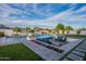 Backyard boasts a luxurious pool, outdoor seating, manicured landscaping, and turf for relaxation and entertainment at 11250 W Prospector Dr, Queen Creek, AZ 85144
