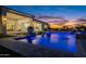 Gorgeous backyard with a pool, water features, and an outdoor kitchen, perfect for outdoor entertaining at 11250 W Prospector Dr, Queen Creek, AZ 85144