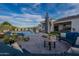 Luxurious backyard featuring a pool, outdoor seating, lush landscaping, and desert views at 11250 W Prospector Dr, Queen Creek, AZ 85144
