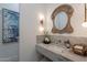 Chic powder room features a marble countertop, unique mirror, and stylish wall art at 11250 W Prospector Dr, Queen Creek, AZ 85144