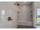 Custom shower featuring bronze fixtures and bench seat with built in storage niche at 11250 W Prospector Dr, Queen Creek, AZ 85144