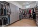 Spacious walk-in closet with custom shelving, drawers, and ample hanging space for organized storage at 11250 W Prospector Dr, Queen Creek, AZ 85144