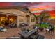 Private back patio has brick flooring, outdoor dining set, and comfortable lounge seating at 12062 W Duane Ln, Peoria, AZ 85383