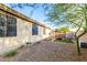 The backyard features low-maintenance landscaping, stone accents, and an open area for exercise equipment at 12062 W Duane Ln, Peoria, AZ 85383