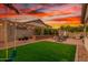 Landscaped backyard featuring vibrant greenery, string lights and a 