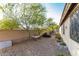 Backyard featuring low-maintenance landscaping and an open area with mature trees and a hammock at 12062 W Duane Ln, Peoria, AZ 85383