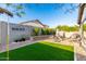 Enjoy the private backyard with artificial grass, built-in BBQ, and beautiful landscaping at 12062 W Duane Ln, Peoria, AZ 85383