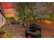 Backyard with desert landscaping, mature trees, string lights and a hammock at 12062 W Duane Ln, Peoria, AZ 85383