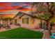 Private backyard with lush green lawn, patio area, and mature landscaping at 12062 W Duane Ln, Peoria, AZ 85383