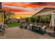 Inviting backyard with a patio, a fire pit, and manicured desert landscaping at 12062 W Duane Ln, Peoria, AZ 85383