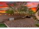Backyard with desert landscaping, mature trees, string lights and a hammock at 12062 W Duane Ln, Peoria, AZ 85383
