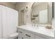 Clean and stylish bathroom with white vanity, brass fixtures, and decorative wall accents at 12062 W Duane Ln, Peoria, AZ 85383