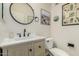 Stylish powder room with a round mirror and decorative cactus artwork at 12062 W Duane Ln, Peoria, AZ 85383