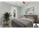 Bright bedroom features a queen bed with neutral linens and a large window with natural light at 12062 W Duane Ln, Peoria, AZ 85383