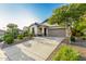 Charming single-story home featuring xeriscaping, a two-car garage, and a welcoming front porch at 12062 W Duane Ln, Peoria, AZ 85383