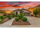Charming single-story home featuring desert landscaping, a two-car garage and a cozy entrance at 12062 W Duane Ln, Peoria, AZ 85383