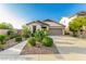Inviting single-story home featuring desert landscaping, a two-car garage and concrete driveway at 12062 W Duane Ln, Peoria, AZ 85383