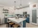 Stylish kitchen with stainless steel appliances, a center island, modern lighting, and a pantry at 12062 W Duane Ln, Peoria, AZ 85383