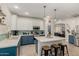 Bright eat-in kitchen featuring a center island, breakfast bar, blue cabinets, and pendant lighting at 12062 W Duane Ln, Peoria, AZ 85383
