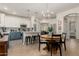 Bright, open kitchen with seating at the island with stainless appliances, open to the dining area at 12062 W Duane Ln, Peoria, AZ 85383