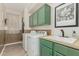 Well-equipped laundry room with green cabinetry and modern washer and dryer at 12062 W Duane Ln, Peoria, AZ 85383