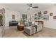 Open living room features tile floors, a piano, and a comfortable sofa, perfect for relaxation at 12062 W Duane Ln, Peoria, AZ 85383