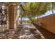 View of the paved walkway in backyard featuring luscious landscaping and block wall at 1211 E Desert Flower Ln, Phoenix, AZ 85048