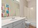 Bathroom showcasing a vanity, mirror and shower-tub combo at 1211 E Desert Flower Ln, Phoenix, AZ 85048
