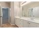 Bathroom featuring double sinks, white cabinets and tile flooring at 1211 E Desert Flower Ln, Phoenix, AZ 85048