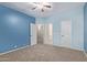 Spacious bedroom featuring neutral carpet, ensuite access and bright ceiling fan at 1211 E Desert Flower Ln, Phoenix, AZ 85048