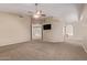 Spacious primary bedroom with neutral carpet, vaulted ceilings, and media center at 1211 E Desert Flower Ln, Phoenix, AZ 85048