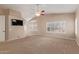 Bright primary bedroom with vaulted ceilings, neutral walls and carpet, and many windows at 1211 E Desert Flower Ln, Phoenix, AZ 85048