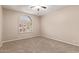 Neutral bedroom showcasing neutral carpet, neutral walls, and large bright window at 1211 E Desert Flower Ln, Phoenix, AZ 85048