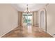 Bright dining area with a chandelier and access to the outdoor pool area at 1211 E Desert Flower Ln, Phoenix, AZ 85048