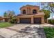 Charming two-story home featuring a tile roof, arched windows, and a spacious three-car garage at 1211 E Desert Flower Ln, Phoenix, AZ 85048