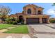 Charming two-story home with lush landscaping, three car garage, and desert surroundings at 1211 E Desert Flower Ln, Phoenix, AZ 85048