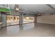 Spacious three car garage with epoxy floors, overhead storage racks, and built-in shelving at 1211 E Desert Flower Ln, Phoenix, AZ 85048