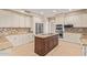 Well-lit kitchen with large island, granite countertops, stainless steel appliances, and ample cabinet space at 1211 E Desert Flower Ln, Phoenix, AZ 85048