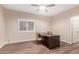Comfortable home office with desk, hardwood floors, and natural light at 1211 E Desert Flower Ln, Phoenix, AZ 85048