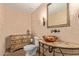 Stylish powder room with unique marble countertop and copper sink at 1211 E Desert Flower Ln, Phoenix, AZ 85048