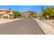 Neighborhood street featuring desert landscaping, mountain backdrop, and well-maintained streets at 1211 E Desert Flower Ln, Phoenix, AZ 85048