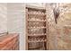 Rustic wine rack built into a stone wall, adding a touch of elegance at 1211 E Desert Flower Ln, Phoenix, AZ 85048